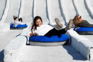 female friends on the outdoor snow tubing hill